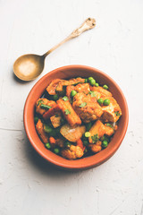Mix vegetable curry - Indian main course recipe contains Carrots, cauliflower, green peas and beans, baby corn, capsicum and paneer/cottage cheese with traditional masala and curry, selective focus