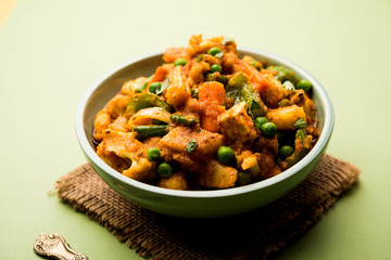 Mix vegetable curry - Indian main course recipe contains Carrots, cauliflower, green peas and beans, baby corn, capsicum and paneer/cottage cheese with traditional masala and curry, selective focus