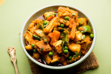 Mix vegetable curry - Indian main course recipe contains Carrots, cauliflower, green peas and beans, baby corn, capsicum and paneer/cottage cheese with traditional masala and curry, selective focus
