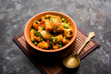 Mix vegetable curry - Indian main course recipe contains Carrots, cauliflower, green peas and beans, baby corn, capsicum and paneer/cottage cheese with traditional masala and curry, selective focus