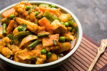 Mix vegetable curry - Indian main course recipe contains Carrots, cauliflower, green peas and beans, baby corn, capsicum and paneer/cottage cheese with traditional masala and curry, selective focus