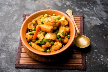 Mix vegetable curry - Indian main course recipe contains Carrots, cauliflower, green peas and beans, baby corn, capsicum and paneer/cottage cheese with traditional masala and curry, selective focus