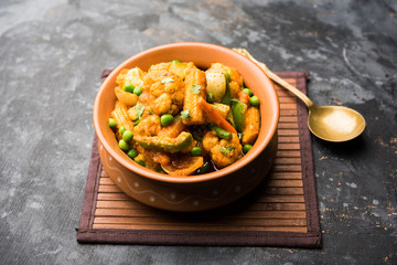 Mix vegetable curry - Indian main course recipe contains Carrots, cauliflower, green peas and beans, baby corn, capsicum and paneer/cottage cheese with traditional masala and curry, selective focus