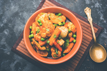 Mix vegetable curry - Indian main course recipe contains Carrots, cauliflower, green peas and beans, baby corn, capsicum and paneer/cottage cheese with traditional masala and curry, selective focus