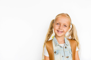 Back to school and happy time. Cute child with blonde hair on white background. Kid with backpack. Girl ready to study. Mockup, place for text, education concept