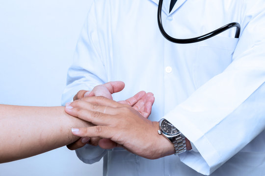 Doctor checking pulse by hand