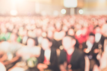 Disfocus of the Speaker on stage and giving talk at business meeting. Audience in the conference hall. Business and Entrepreneurship.
