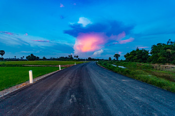 Road  and field on evening thailand.