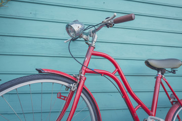 red vintage bicyle parking on blue wooden wall