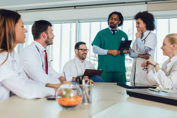 Medical team sitting and discussing at the table in the office.