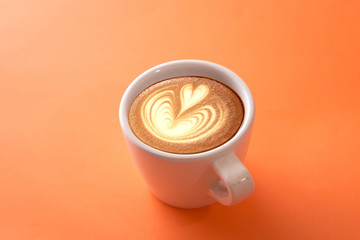 cup of coffee on orange background