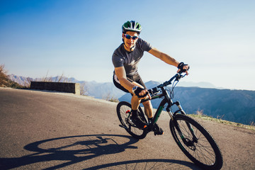 Fototapeta na wymiar Man ride mountain bike on the road. Sport and active life concept.