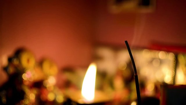 Blur shot of a joss stick agarbatti and lamp hindu prayer scene of temple religious