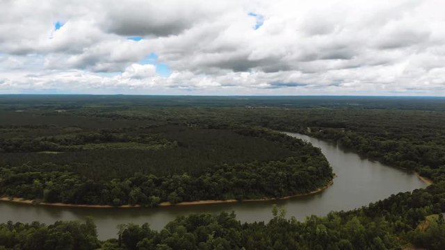 This is a time lapse of a cloudy day over a bend in the Black Warrior River that runs through the state of Alabama. The clip captures the natural beauty of the surrounding landscape in great detail.