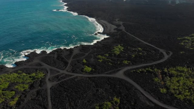 Aerial over the former Kapoho bay, just recently taken by lava in 2018. the bay is now replaced by a black sand beach created from red hot lava hitting the cold ocean and shattering into black sand.