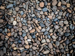 Black, grey, brown stone natural mineral rocks and pebbles in park outdoor textured background