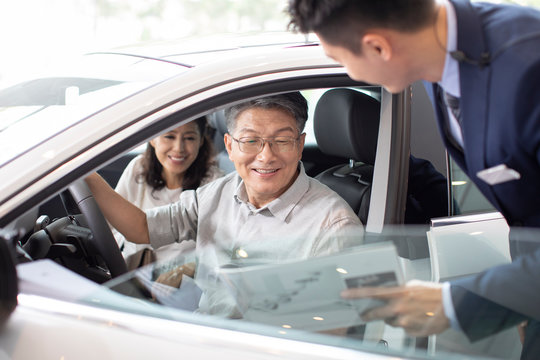 Happy mature couple taking a test drive