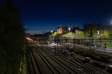 Fototapeta na wymiar Helsinki cityscape and railtracks by night at Linnunlaulu overpass