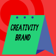 Word writing text Creativity Brand. Business photo showcasing design name or feature that distinguishes organization Open big standing calendar Desk monthly planner Geometrical background