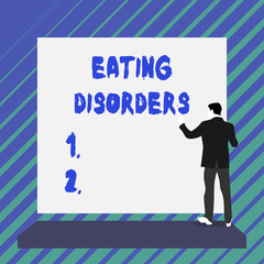 Writing note showing Eating Disorders. Business concept for any of a range of psychological abnormal food habits Short hair immature young man stand in front of rectangle big board