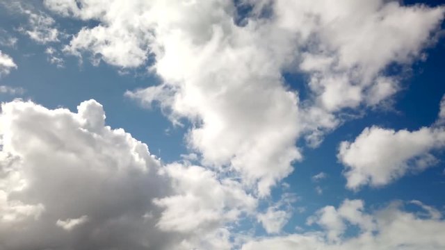 Cumulus clouds in blue sky billow and form, cloudscape time lapse