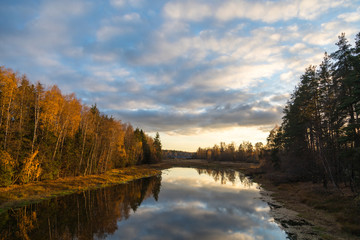 autumn landscape with lake and blue sky
