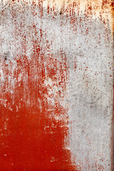 Rusty iron surface unevenly coated with red, white and blue paint with smudges