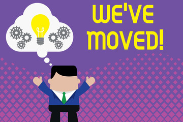 Conceptual hand writing showing We Ve Moved. Concept meaning To go from one residence or location to another Relocate Man hands up imaginary bubble light bulb working together