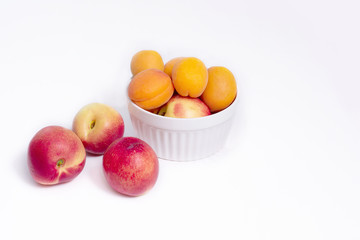 Group of whole nectarine and apricots fruit isolated on white background