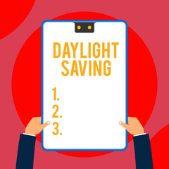 Text sign showing Daylight Saving. Business photo text Storage technologies that can be used to protect data Two executive male hands holding electronic device geometrical background