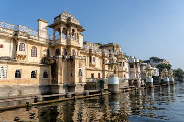Fototapeta premium Architecture, decorated facade near water lake in Udaipur, Rajasthan, India