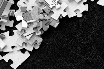 Children's puzzles on a dark background close up. Black and white