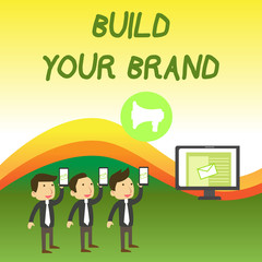 Naklejka premium Conceptual hand writing showing Build Your Brand. Concept meaning enhancing brand equity using advertising campaigns SMS Email Marketing Media Audience Attraction PC Loudspeaker