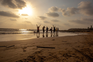 Fototapeta na wymiar People enjoying the beach at sunset