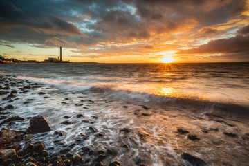 Dawn on Downshire Beach, Carrickfergus, Northern Ireland with Kilroot Power Station in the distance.