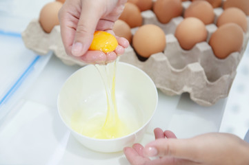 Close-up view, separate egg yolk on the hands female for made bakery ingredient and cooking