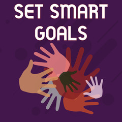 Writing note showing Set Smart Goals. Business concept for giving criteria to guide in the setting of objectives Hand Marks of Different Sizes for Teamwork and Creativity