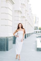  Summer look and white dress. Portraits of an elegant girl with luxury apartments.