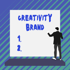 Writing note showing Creativity Brand. Business concept for design name or feature that distinguishes organization Short hair immature young man stand in front of rectangle big board