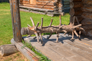 An old harrow from a tree trunk on a porch in a 10th century Russian peasant house