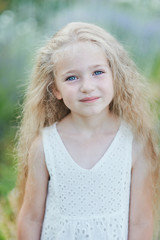 Fototapeta premium Close up portrait of pretty, young, blue eyed, fair skinned girl with happy and peaceful expression