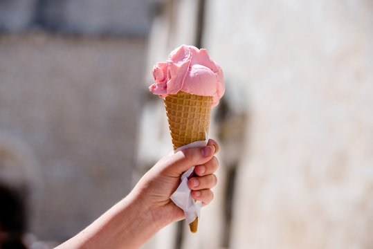 A Man Holding A Horn With Pink Ice Cream