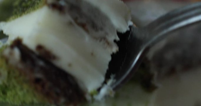 utting piece of appetizing fresh biscuit pastry cake with strawberry jam extreme close-up. Amazing tasty dessert food using fork and knife enjoying beautiful serving dishes macro shot