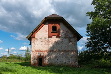 Collapsing two-story brick house in the park on a summer day
