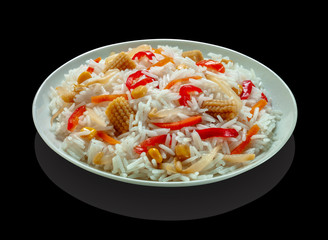 Rice salad with little corn, red pepper and soy bean sprouts, black table