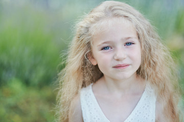 Fototapeta premium Close up portrait of pretty, young, blue eyed, fair skinned girl with happy and peaceful expression