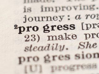 Dictionary definition of word progress, selective focus.