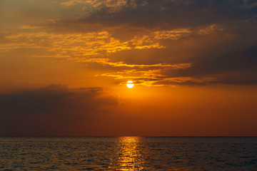 Colorful sunset over calm sea water near tropical beach. Summer vacation concept. Island Phangan, Thailand