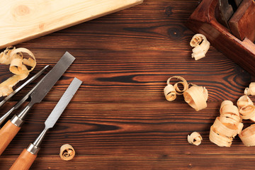 chisels plane and sawdust on a wooden table.