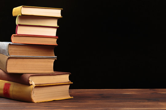Stack of books on a black  background.Education